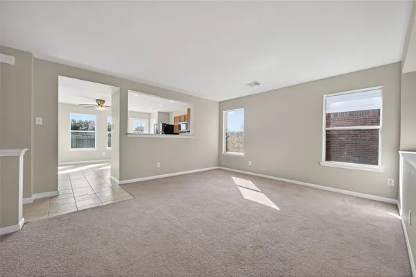 a view of an empty room with windows