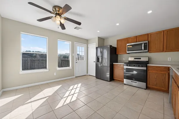 a kitchen with granite countertop a refrigerator and a sink