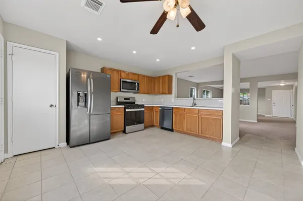 an empty room with windows and fan