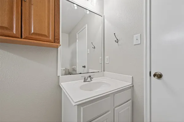 a bathroom with a toilet sink and a mirror