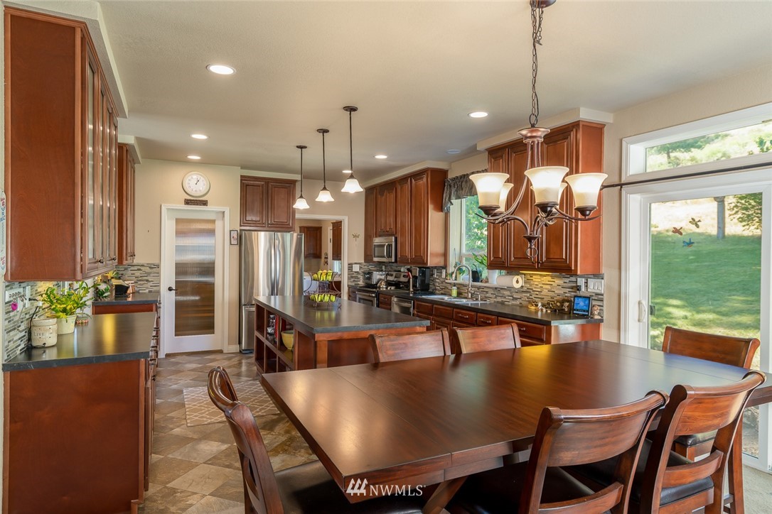 3111 Bettas Road Cle Elum, WA 98922 - Photo 8 of 21 a view of a dining room and livingroom with furniture wooden floor a chandelier