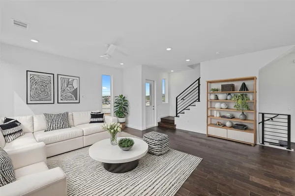 a living room with furniture and a wooden floor