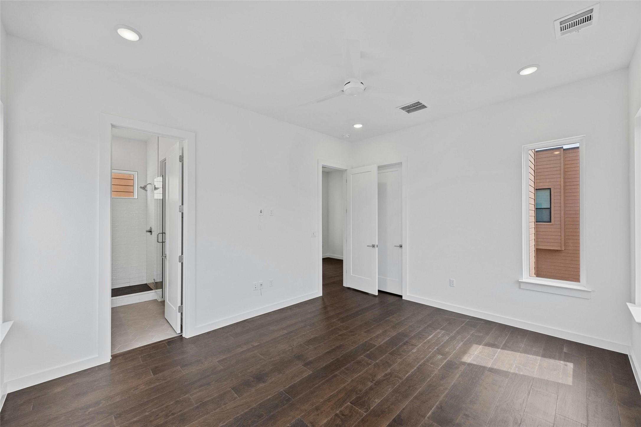 6825 Wolfcreek Pass, Unit 2 Austin, TX 78749 - Photo 14 of 34 an empty room with wooden floor and windows