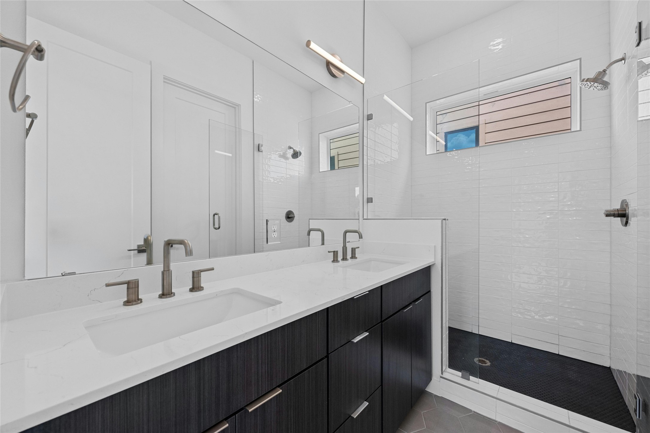 6825 Wolfcreek Pass, Unit 2 Austin, TX 78749 - Photo 15 of 34 a bathroom with a double vanity sink a mirror and a shower