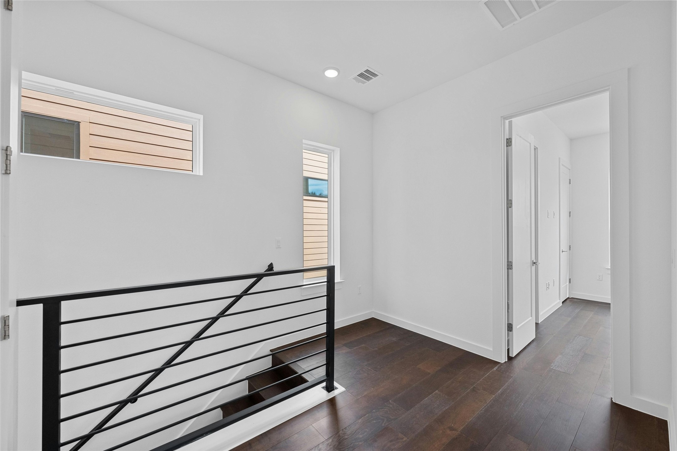 6825 Wolfcreek Pass, Unit 2 Austin, TX 78749 - Photo 16 of 34 a view of a hallway with wooden floor and stairs