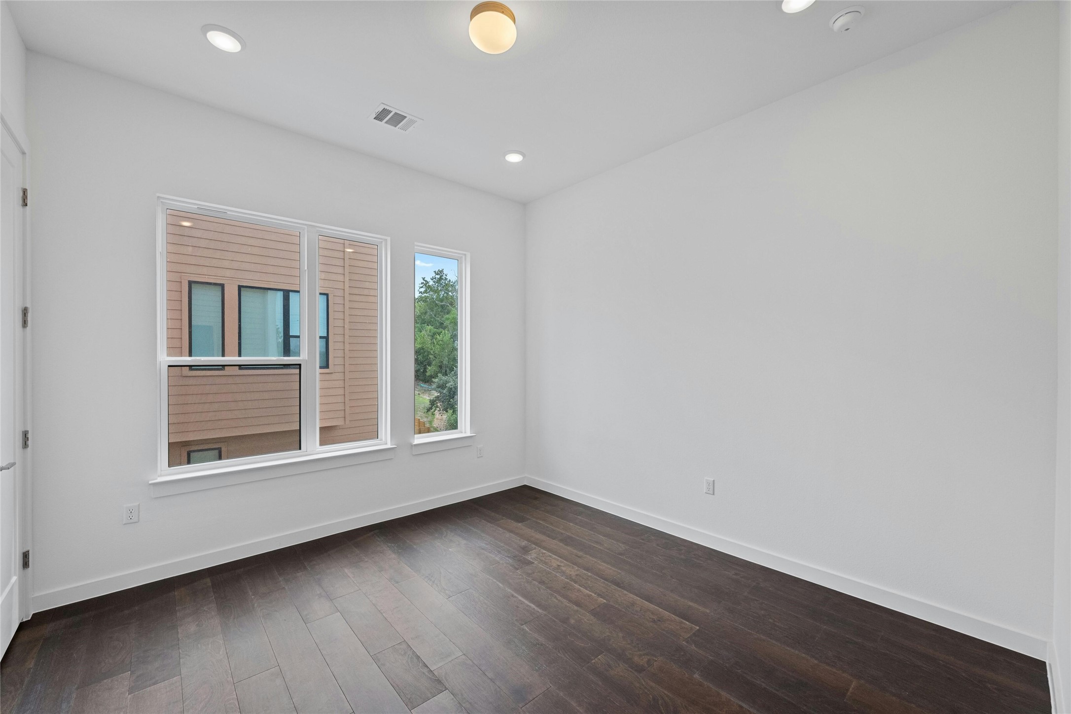 6825 Wolfcreek Pass, Unit 2 Austin, TX 78749 - Photo 18 of 34 an empty room with wooden floor and windows