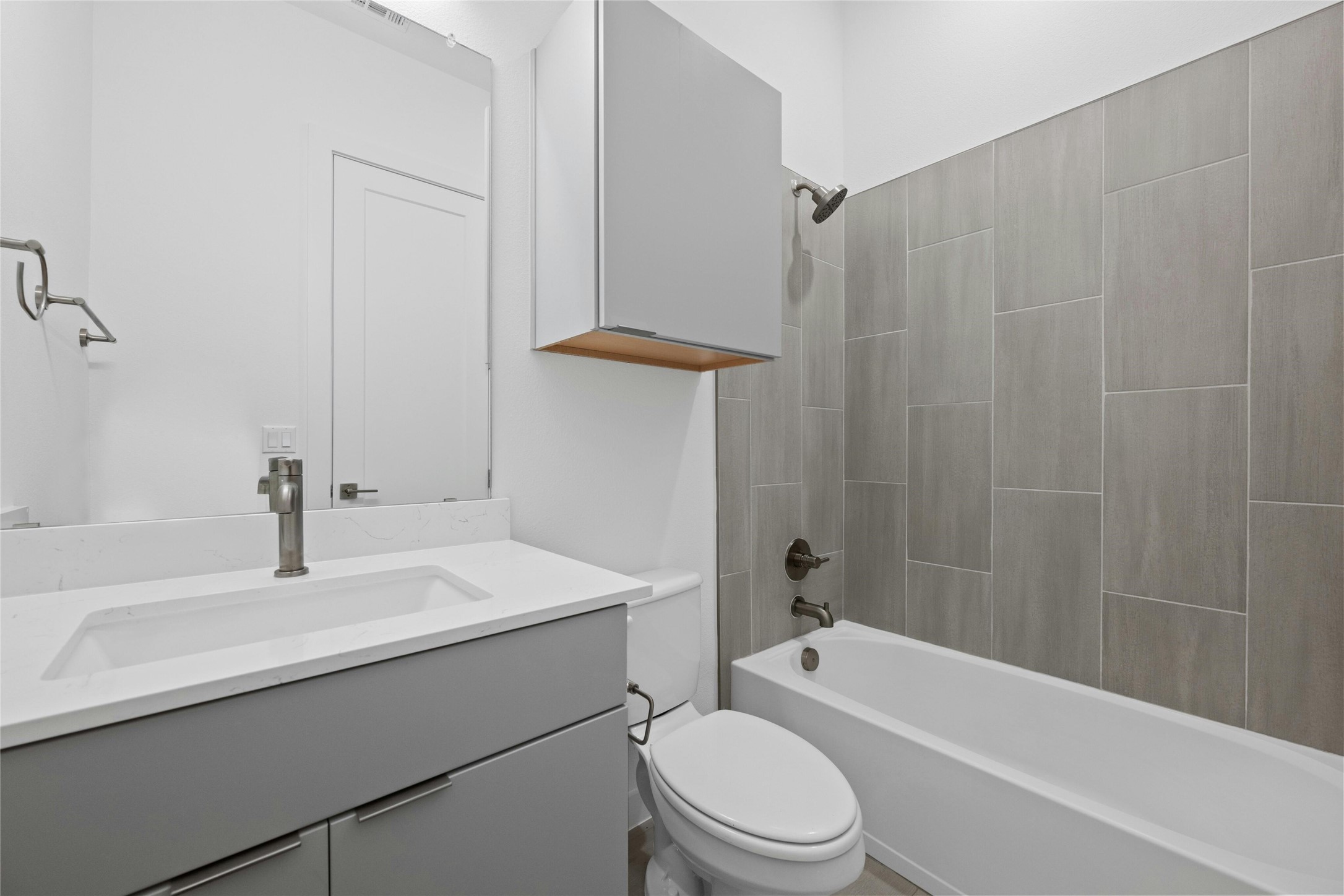 6825 Wolfcreek Pass, Unit 2 Austin, TX 78749 - Photo 19 of 34 a bathroom with a sink a toilet and shower