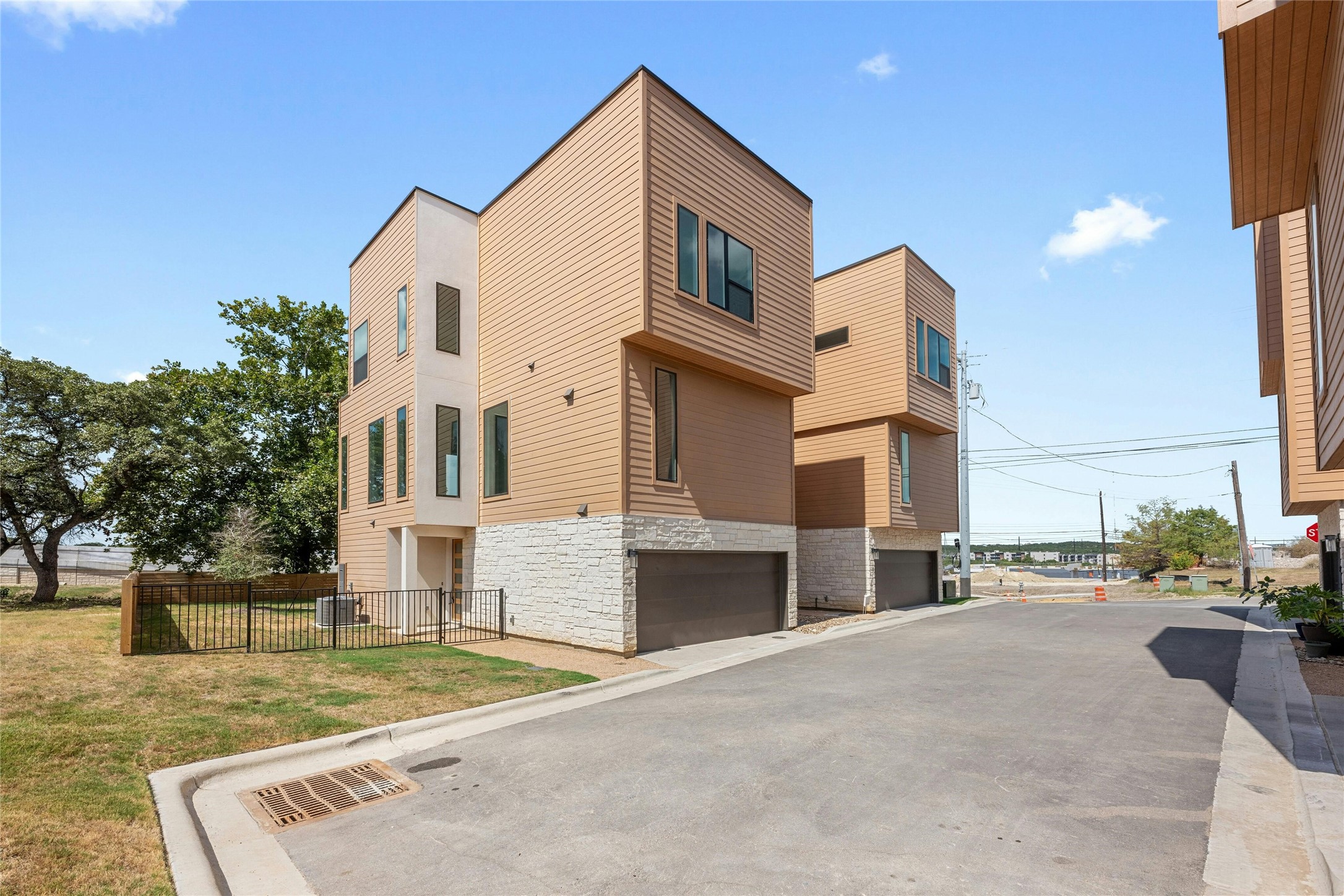 6825 Wolfcreek Pass, Unit 2 Austin, TX 78749 - Photo 2 of 34 a front view of a house with a yard and garage