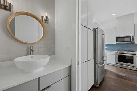 a bathroom with a sink a toilet and a mirror