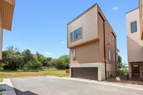 a view of a house with a yard and a garage