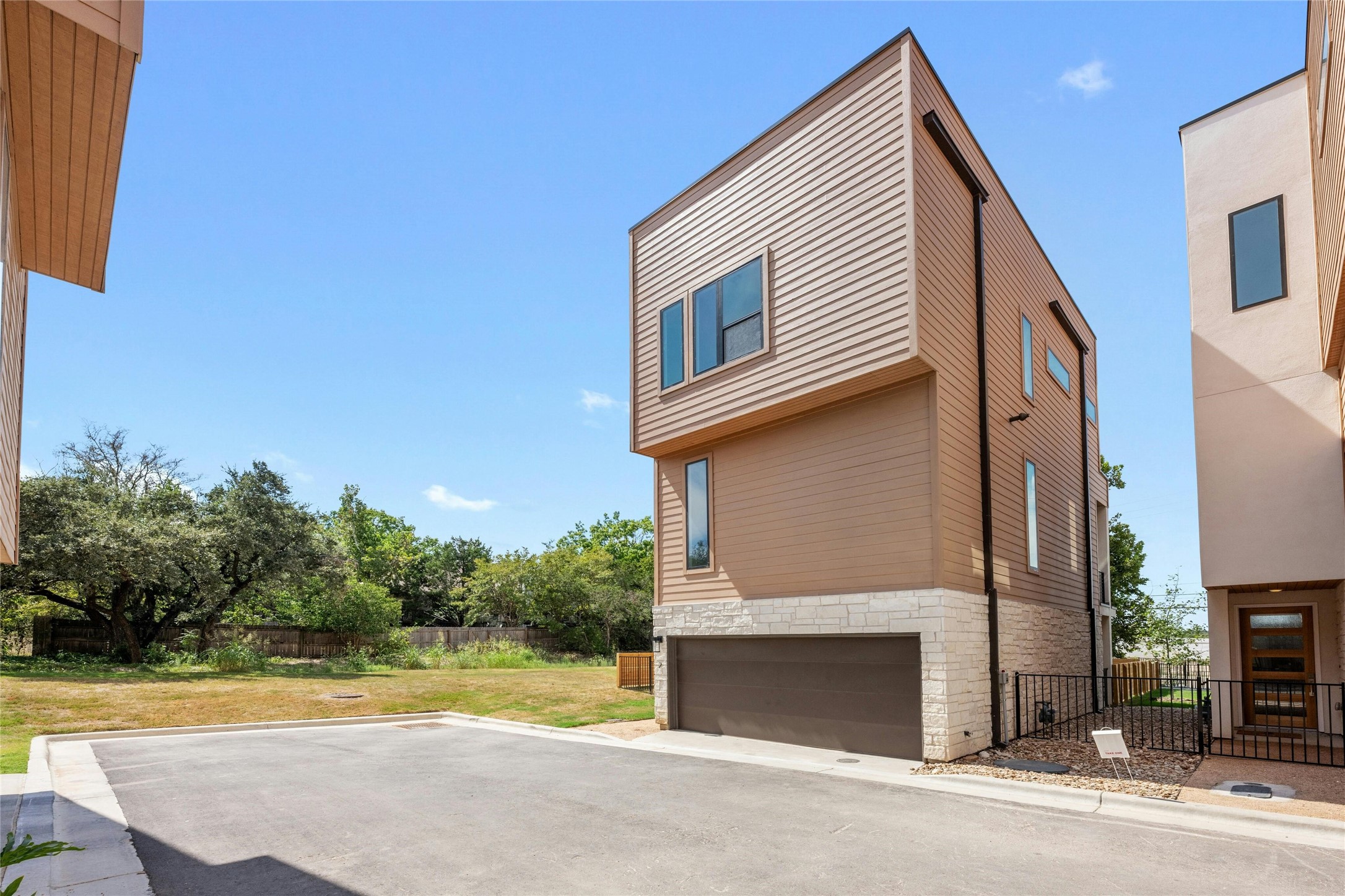 6825 Wolfcreek Pass, Unit 2 Austin, TX 78749 - Photo 27 of 34 a view of a house with a yard and a garage