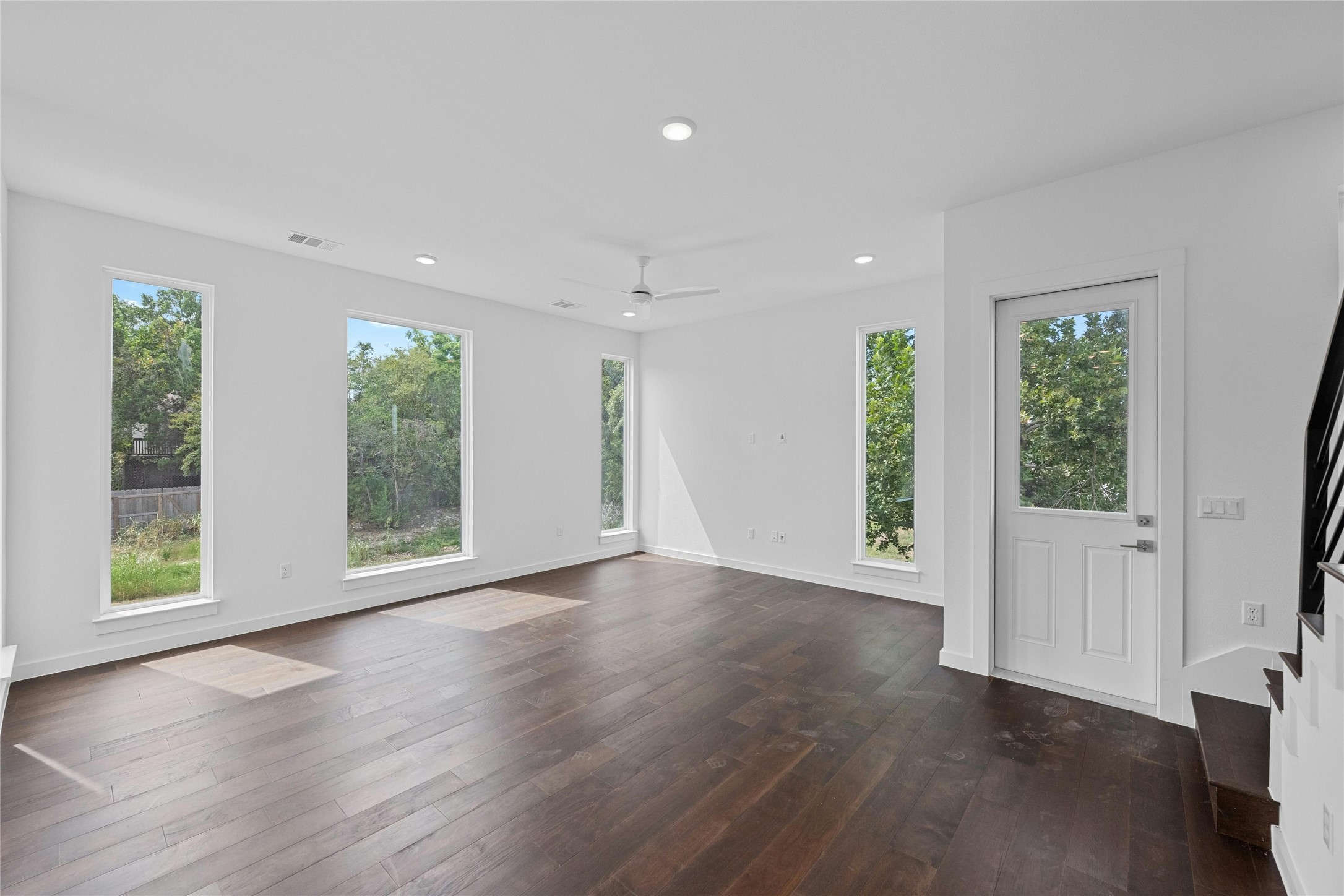 6825 Wolfcreek Pass, Unit 2 Austin, TX 78749 - Photo 4 of 34 a view of an empty room with wooden floor and a window