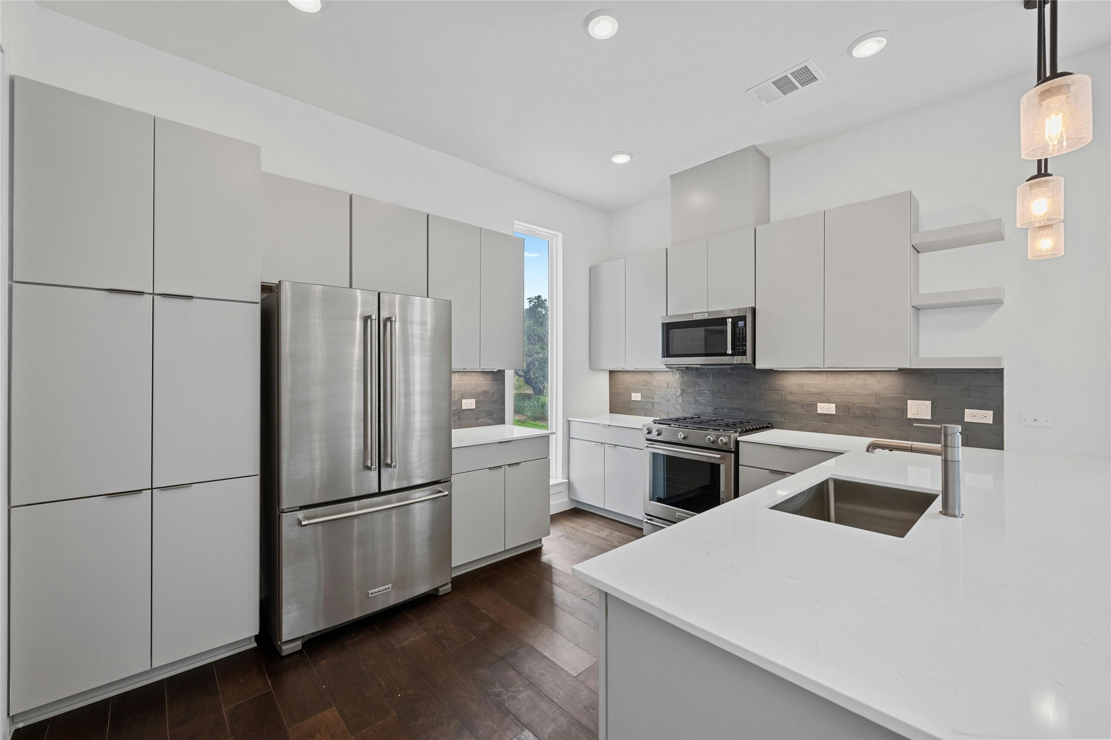 6825 Wolfcreek Pass, Unit 2 Austin, TX 78749 - Photo 8 of 34 a kitchen with a refrigerator sink and cabinets