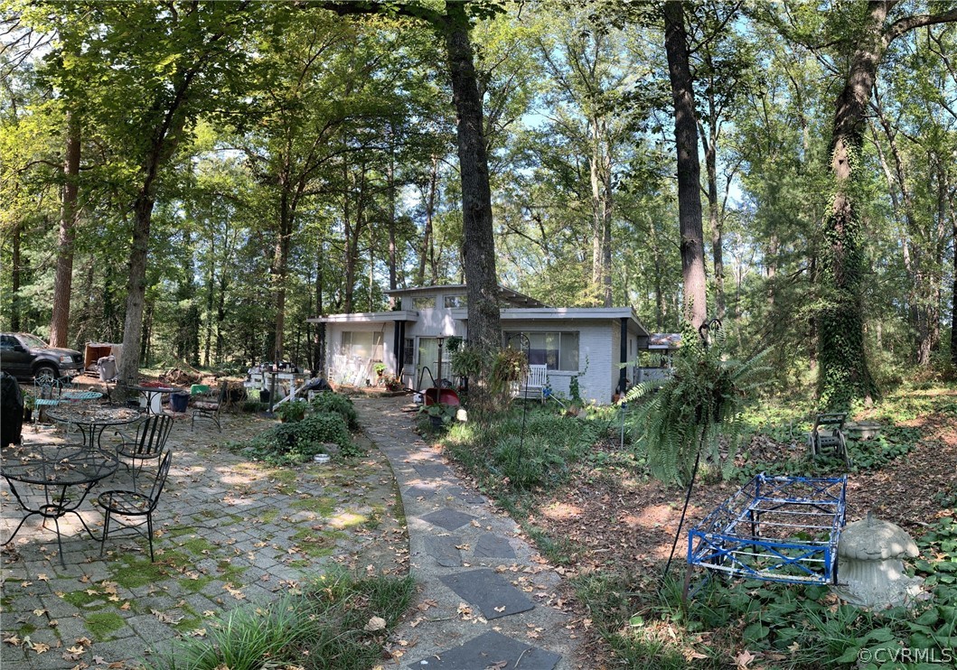 1832 Manakin Road Manakin-Sabot, VA 23103 - Photo 3 of 23 a backyard of a house with table and chairs under an umbrella
