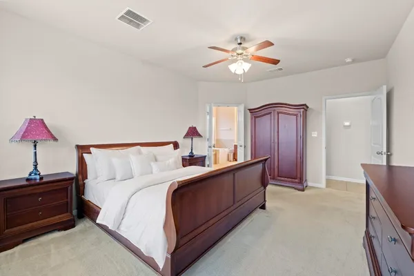 a spacious bedroom with a bed and a desk