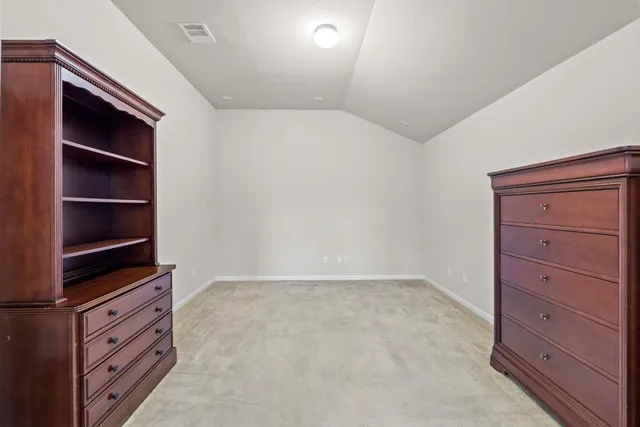 a view of a room with table and chairs