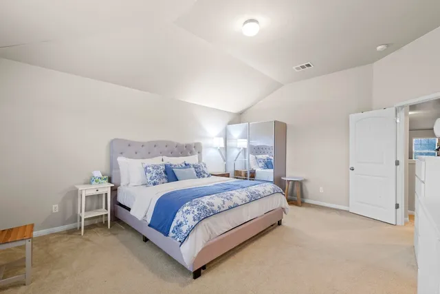 a spacious bedroom with a bed and a window