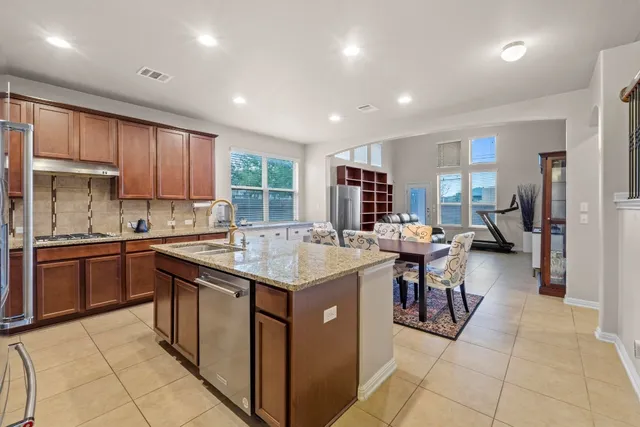 a kitchen with counter top space appliances and a center island