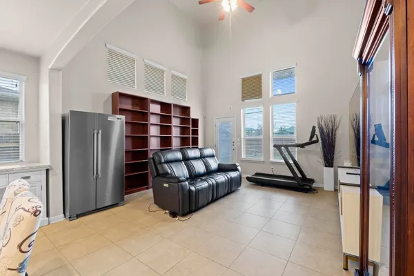 a living room with furniture gym equipment and a window