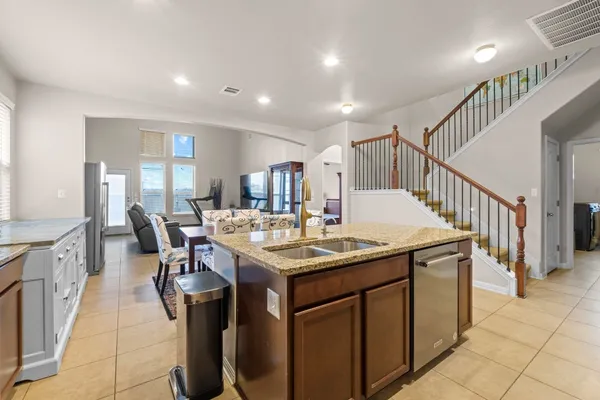 a view of a house with a big yard and potted plants