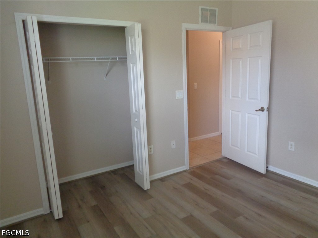 2463 Nature Pointe Loop Fort Myers, FL 33905 - Photo 40 of 50 an empty room with wooden floor and closet