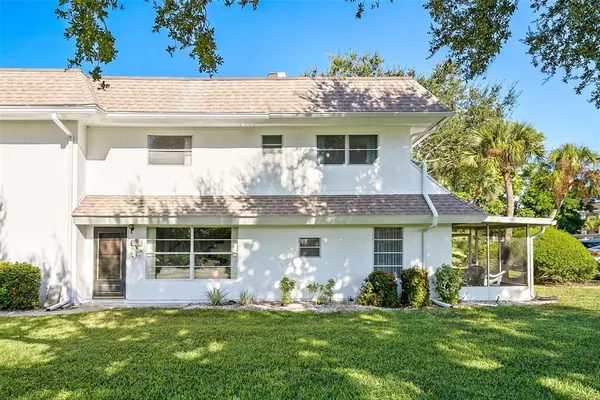 a front view of a house with a yard and porch