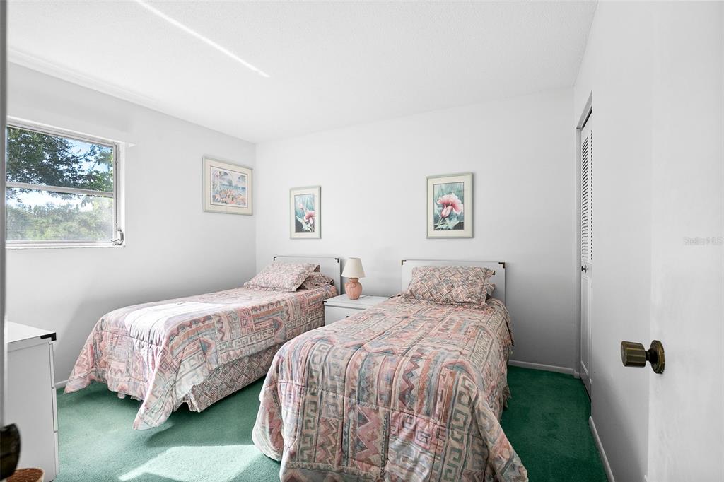 597 Sutton Place Longboat Key, FL 34228 - Photo 20 of 49 a bedroom with double bed and a window