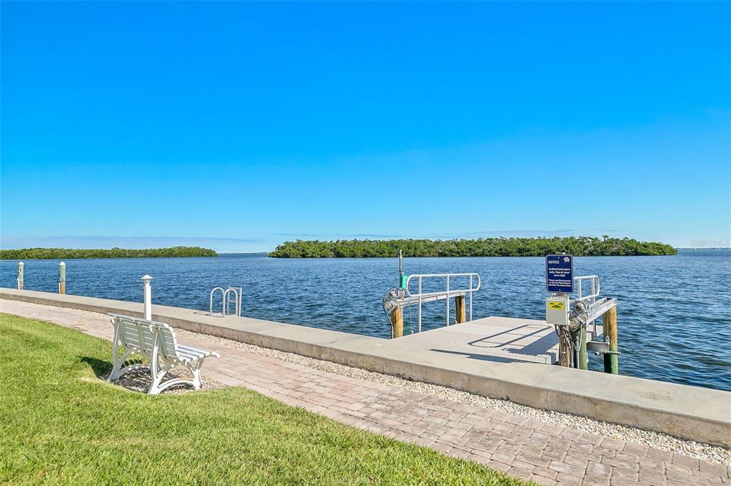 597 Sutton Place Longboat Key, FL 34228 - Photo 24 of 49 a view of a lake with a terrace