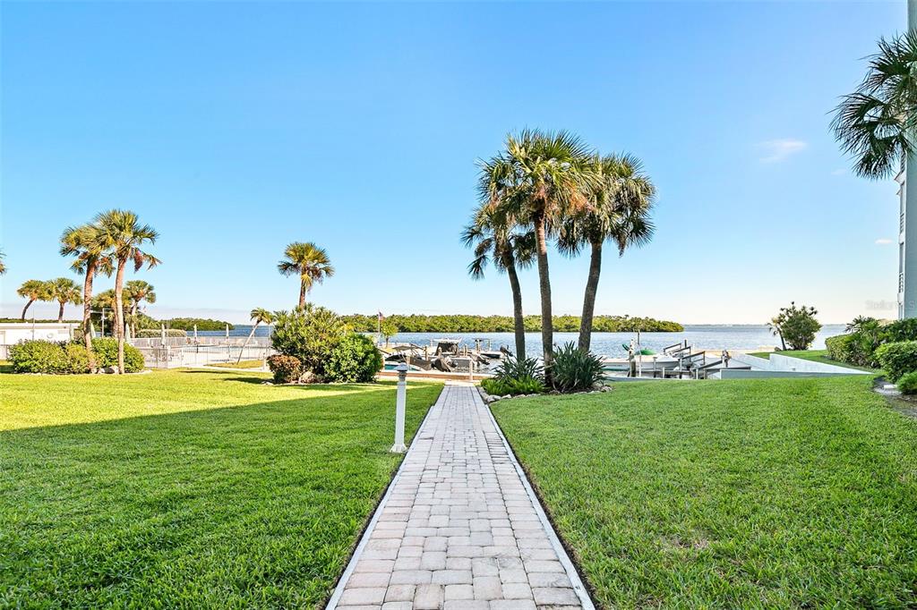 597 Sutton Place Longboat Key, FL 34228 - Photo 30 of 49 a view of a garden with a lake