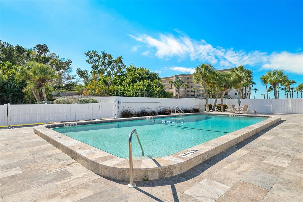 597 Sutton Place Longboat Key, FL 34228 - Photo 33 of 49 a view of a pool in a backyard