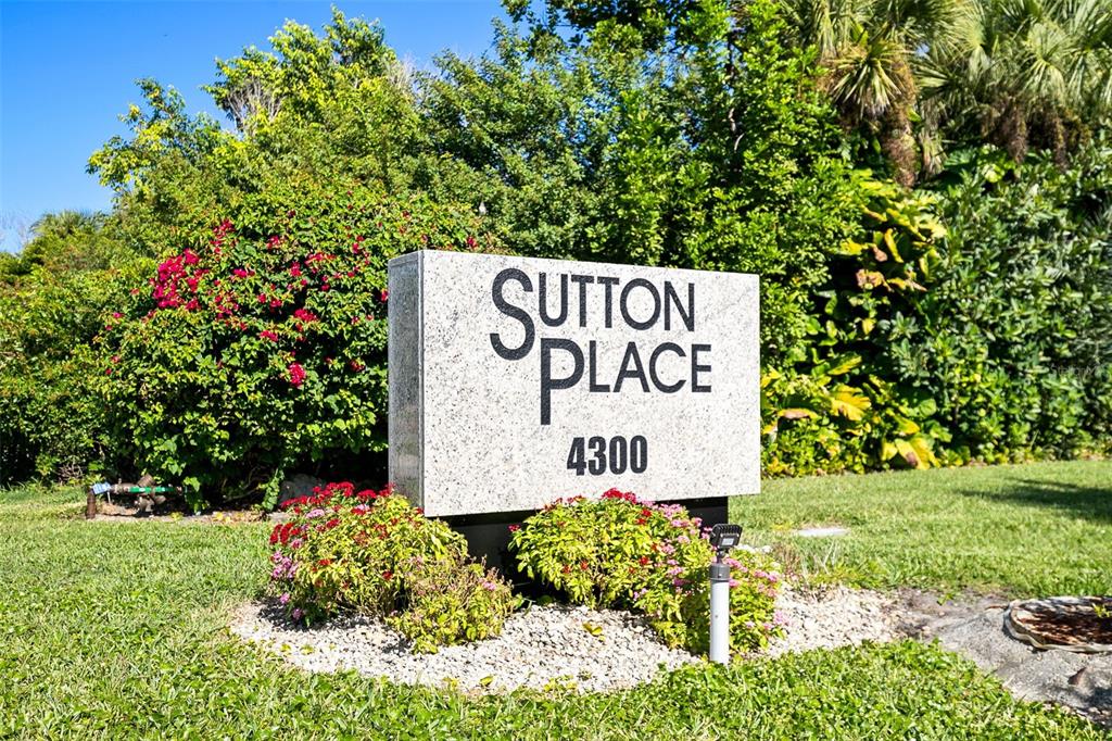 597 Sutton Place Longboat Key, FL 34228 - Photo 38 of 49 a sign that is sitting on a green field