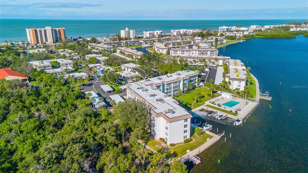 597 Sutton Place Longboat Key, FL 34228 - Photo 49 of 49 an aerial view of a house with swimming pool and ocean view