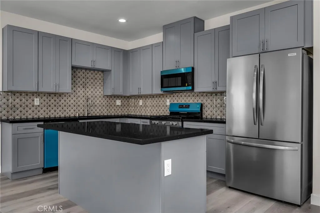 1509 West 87th Street Los Angeles, CA 90012 - Photo 4 of 14 Kitchen with a Center Island & Stainless Appliances.