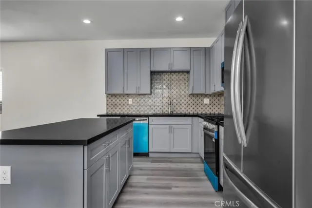 a kitchen with stainless steel appliances granite countertop a sink and cabinets