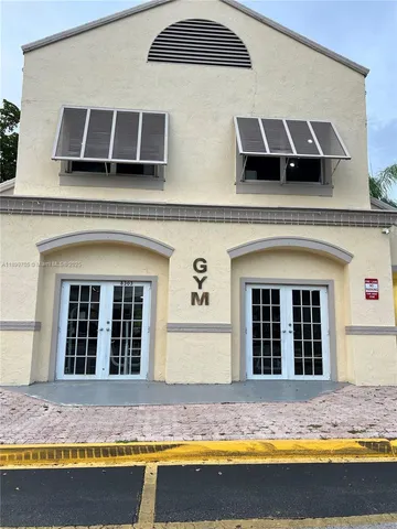 a view of a brick house with large windows