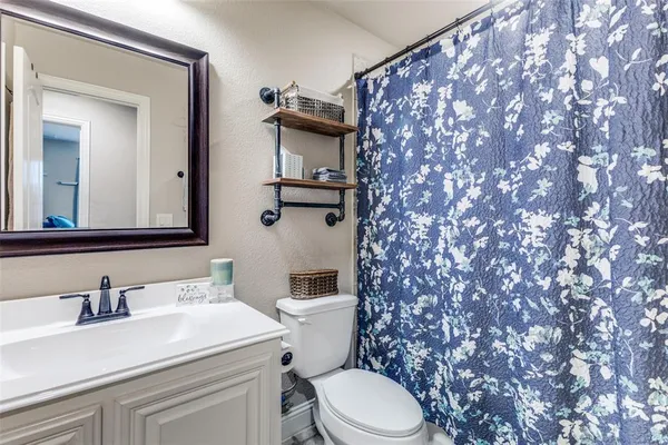 a bathroom with a sink toilet and mirror