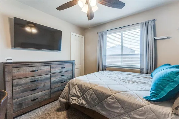 a bedroom with a large bed and a flat screen tv