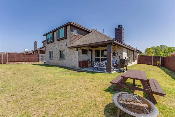 a front view of a house with yard and patio