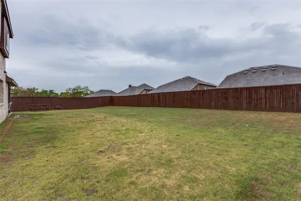 a view of swimming pool with outdoor seating and yard in back