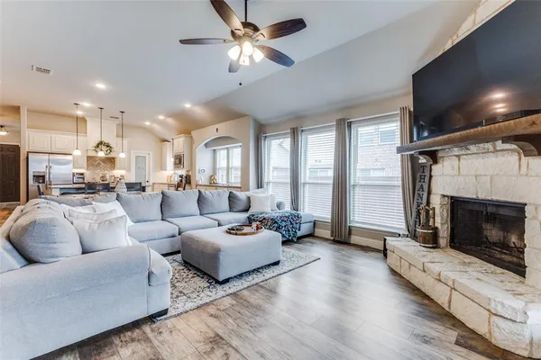 a living room with furniture a fireplace and a flat screen tv