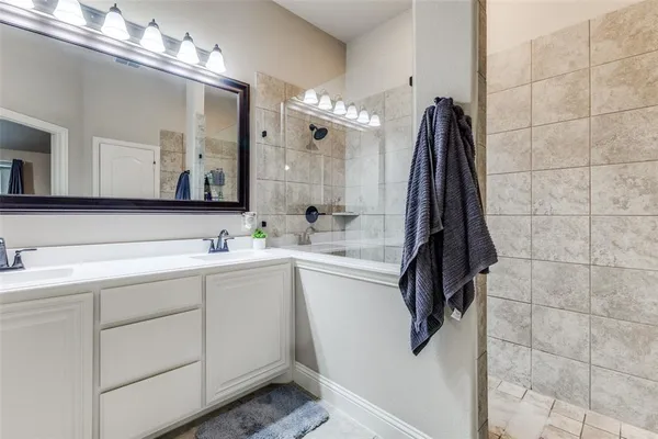 a bathroom with a sink vanity and a mirror