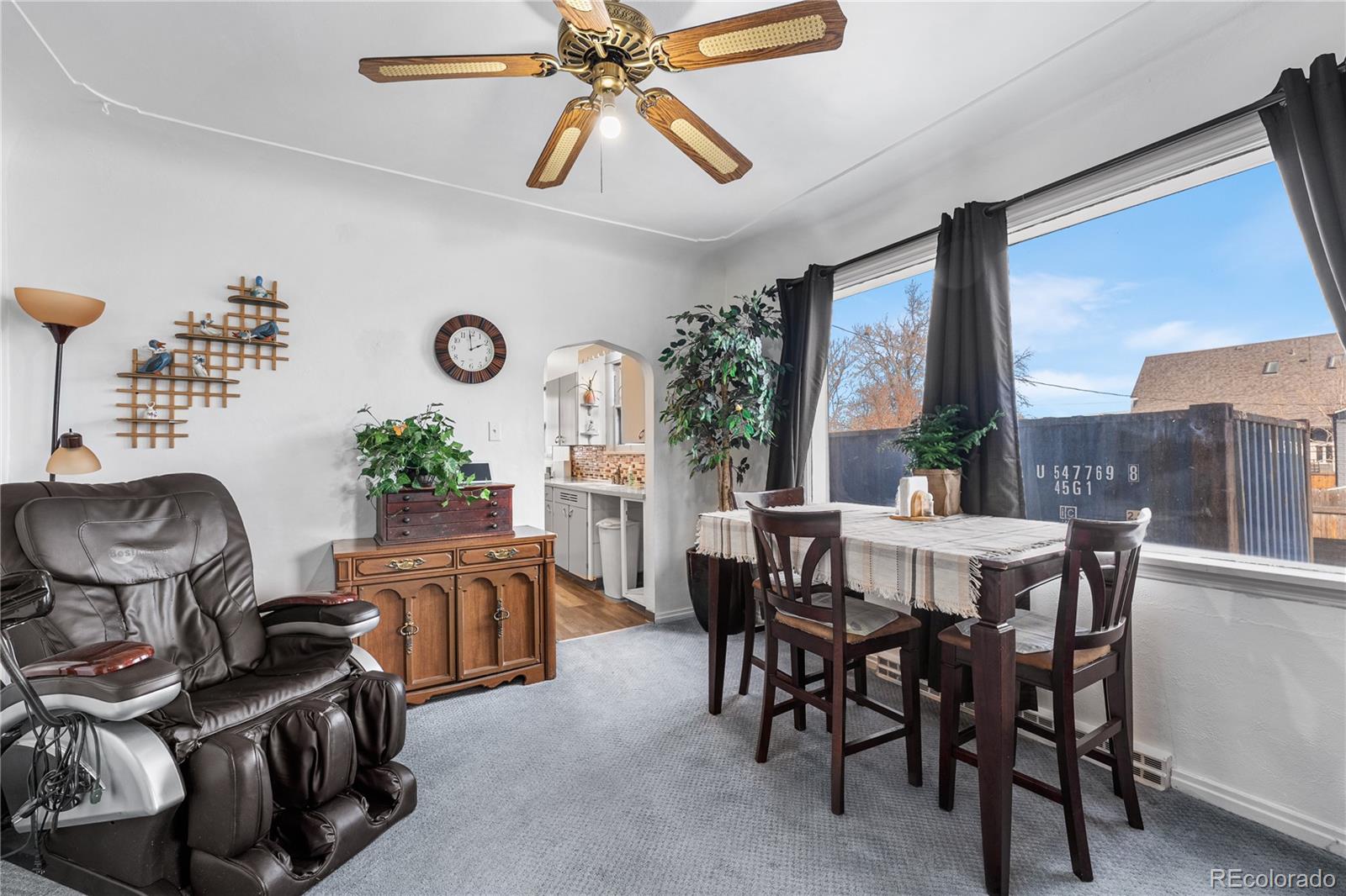 6145 West 38th Avenue Wheat Ridge, CO 80033 - Photo 9 of 39 a view of a dining room with furniture window and outside view