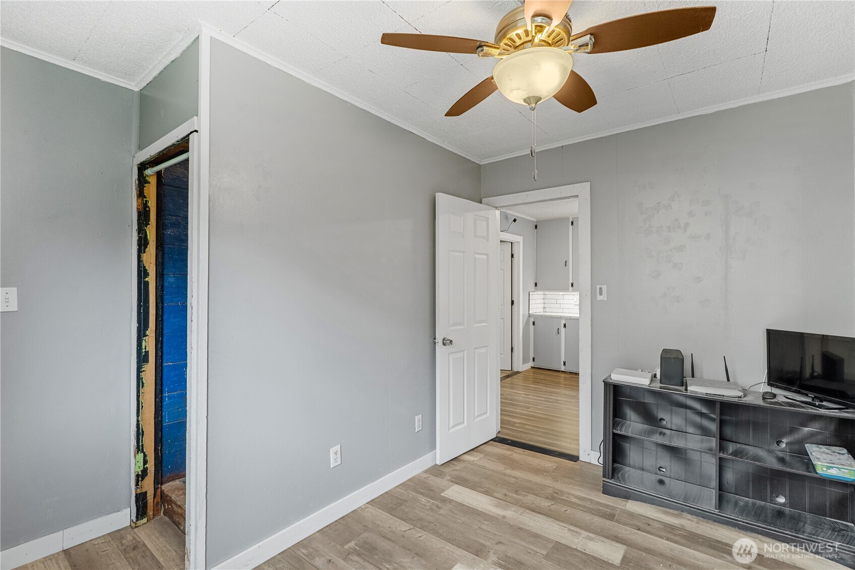 2405 1st Street Cosmopolis, WA 98537 - Photo 13 of 36 a bedroom with a bed and a chandelier