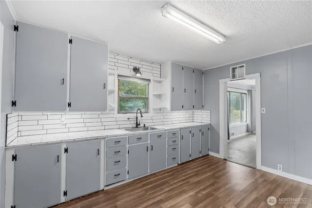 a spacious bathroom with a double vanity sink and a mirror