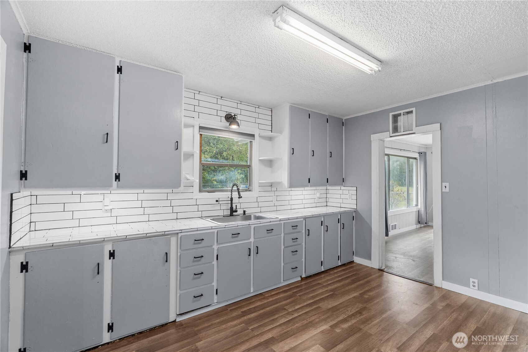 2405 1st Street Cosmopolis, WA 98537 - Photo 17 of 36 a spacious bathroom with a granite countertop double vanity sink and mirror