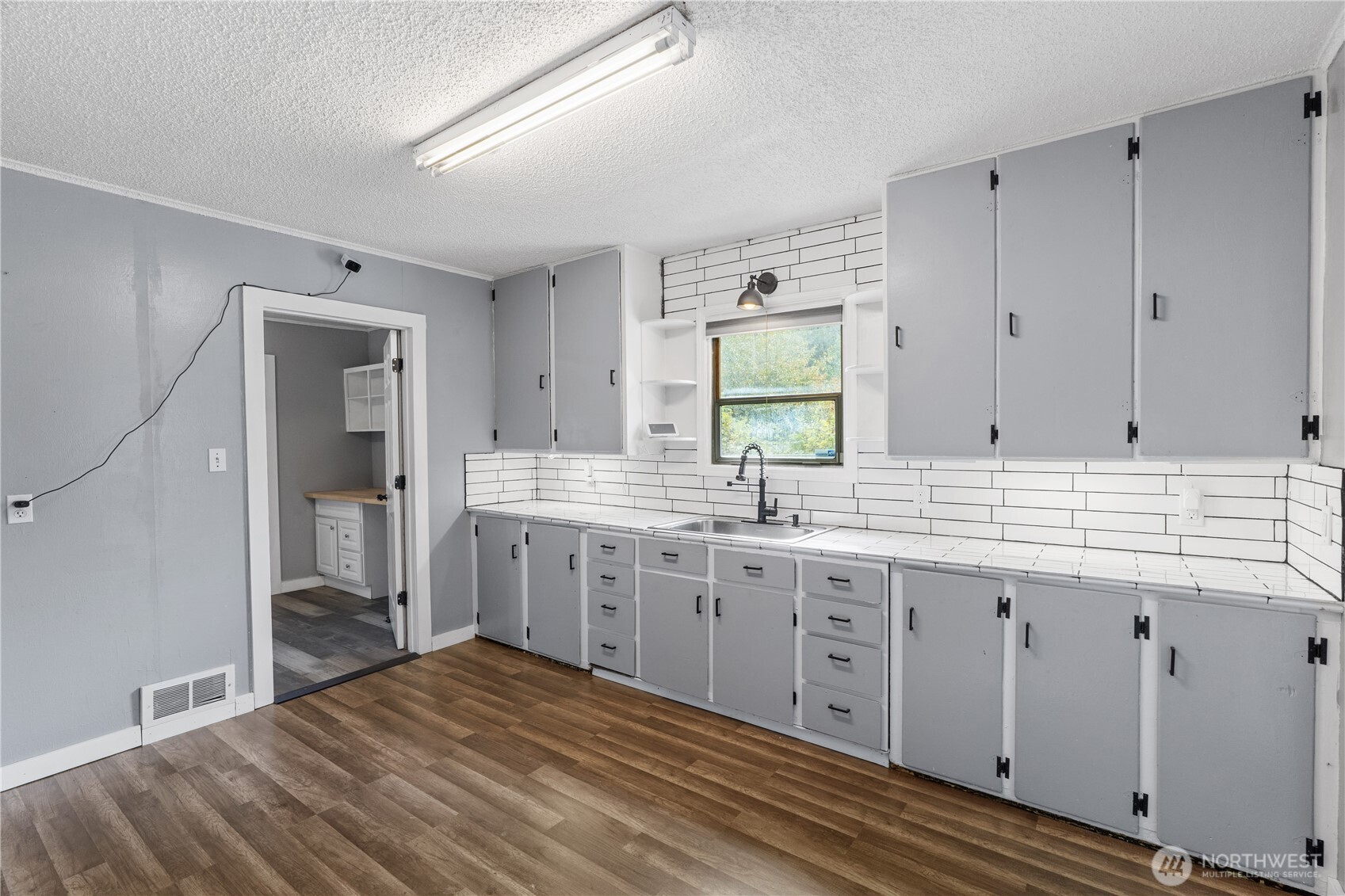 2405 1st Street Cosmopolis, WA 98537 - Photo 19 of 36 a spacious bathroom with a granite countertop sink a mirror and a bathtub