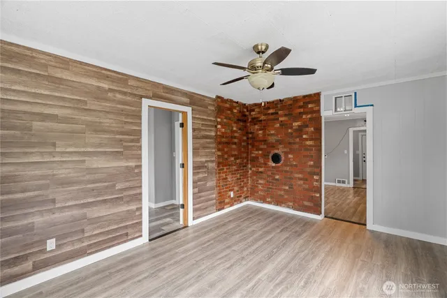 a view of empty room with wooden floor and window