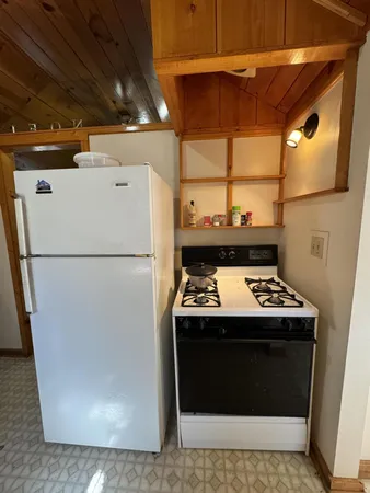 a stove top oven sitting inside of a kitchen