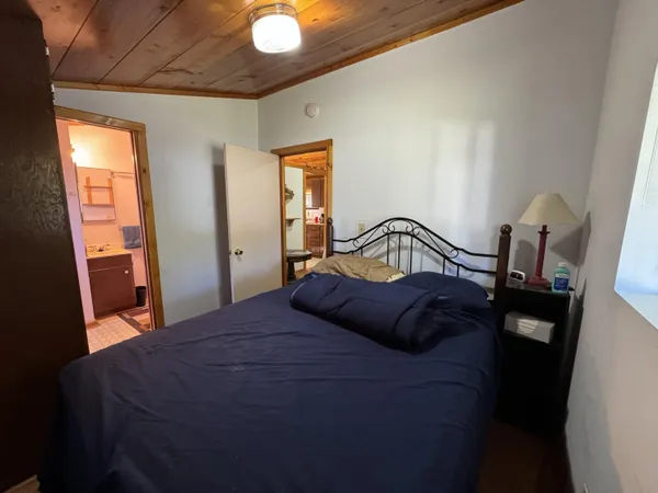 a bedroom with a bed and window