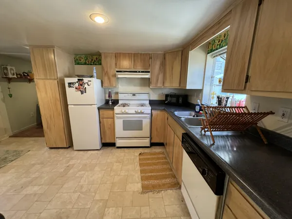 a kitchen with stainless steel appliances granite countertop a stove and a refrigerator